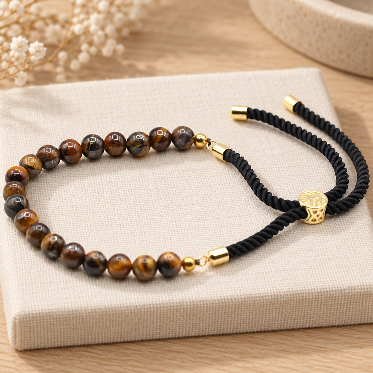 Gold Plated Tiger Eye Black String Bracelet in a muted gift setting